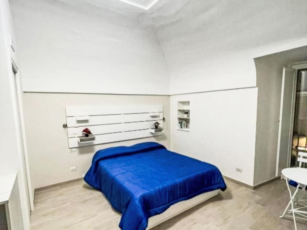 a bedroom with a blue bed and a table at Apartment Il Balconcino di Sorrento by Interhome in Sorrento