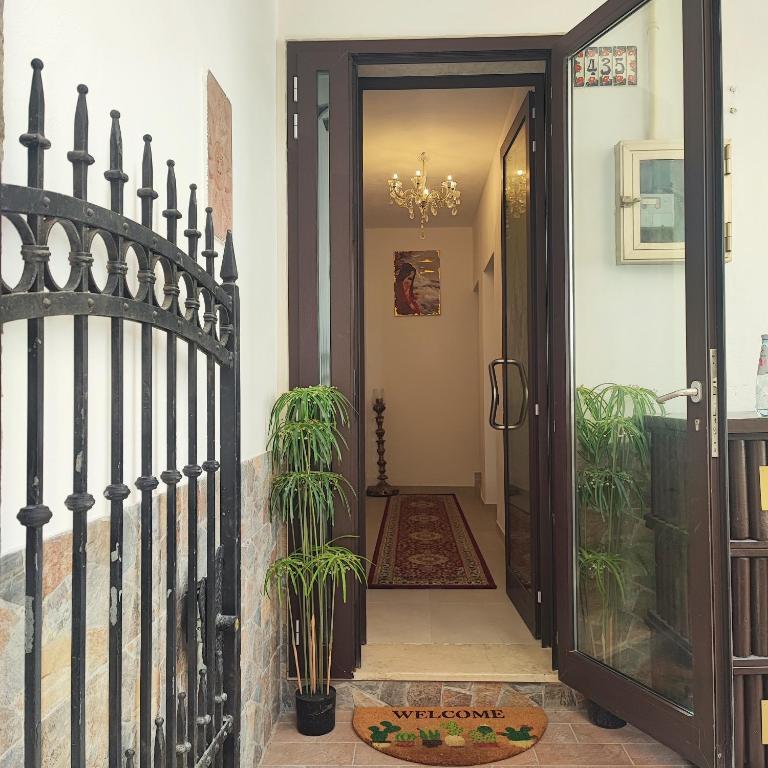 a black gate leading to a hallway with plants at Ca Giulia in Chioggia