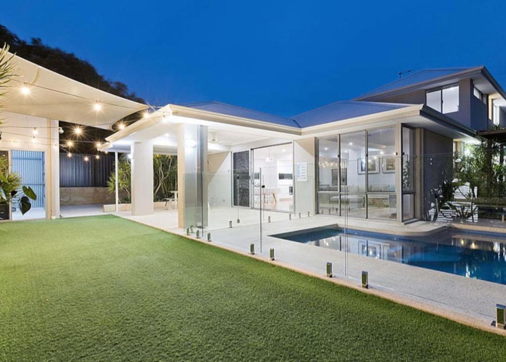 a house with a swimming pool and a yard at MiaMia Ultra Modern Home with Pool and Courtyard in Perth