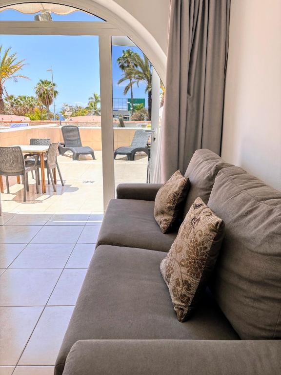 a couch in a living room with a view of the ocean at Estudio en Paraiso Royal in Arona