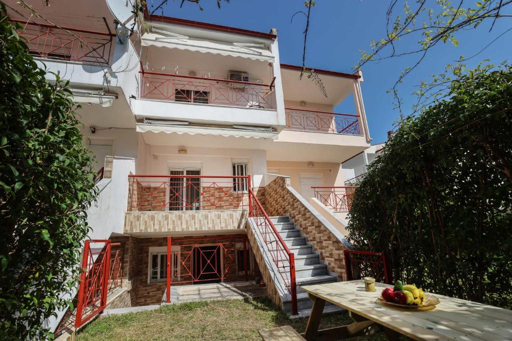a building with stairs and a table in front of it at Holiday Apartment Fourka in Skala Fourkas