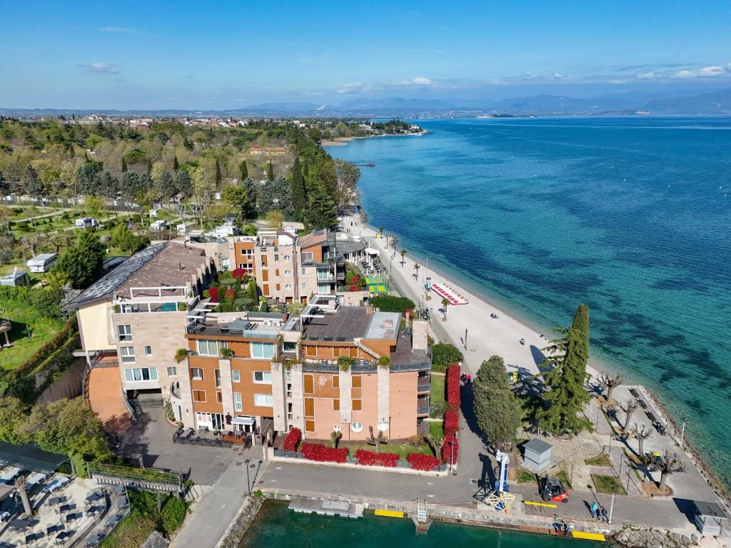 an aerial view of a building next to the water at MGH Luxury - Residenza La Perla Peschiera Lakefront in Peschiera del Garda