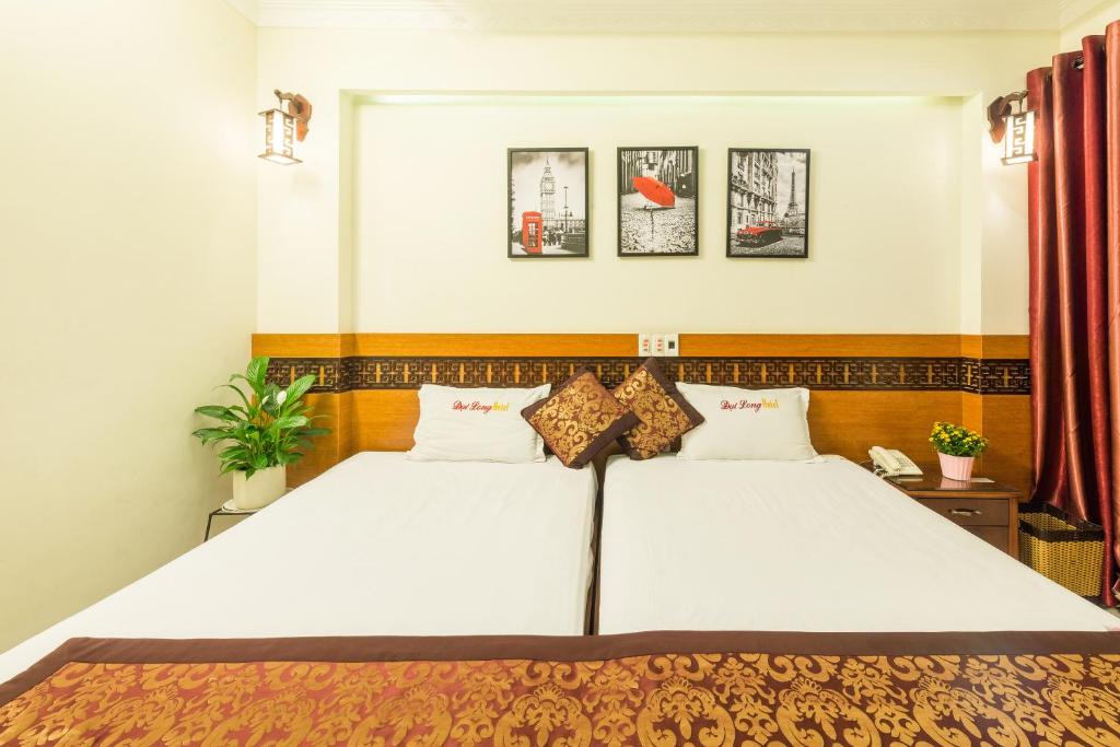 Postel nebo postele na pokoji v ubytování Dai Long Hotel