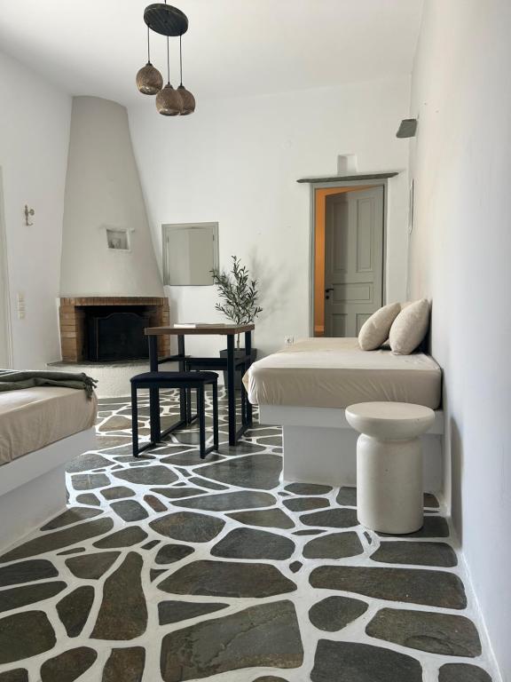 a bedroom with a bed and a table and a rug at Lithari Traditional Apartment in Agios Sostis