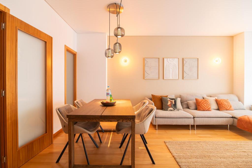 a living room with a table and a couch at URBAN PDL Flat II in Ponta Delgada