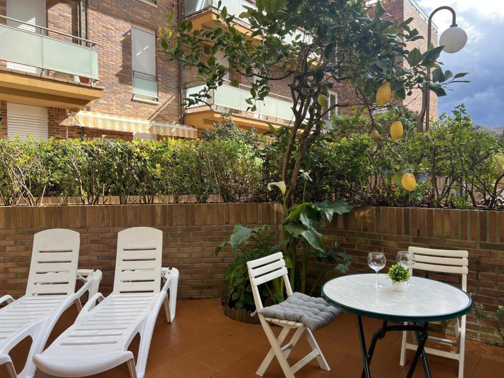 a patio with a table and chairs and a building at Circobueno de Isla - 5609 in Arnuero