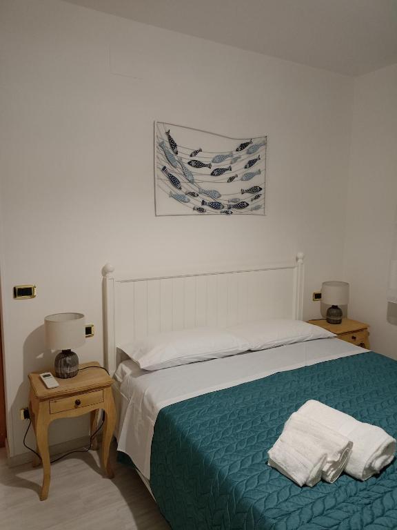 a bedroom with a bed with two towels on it at Da Margot - Appartamento al mare in Grottammare