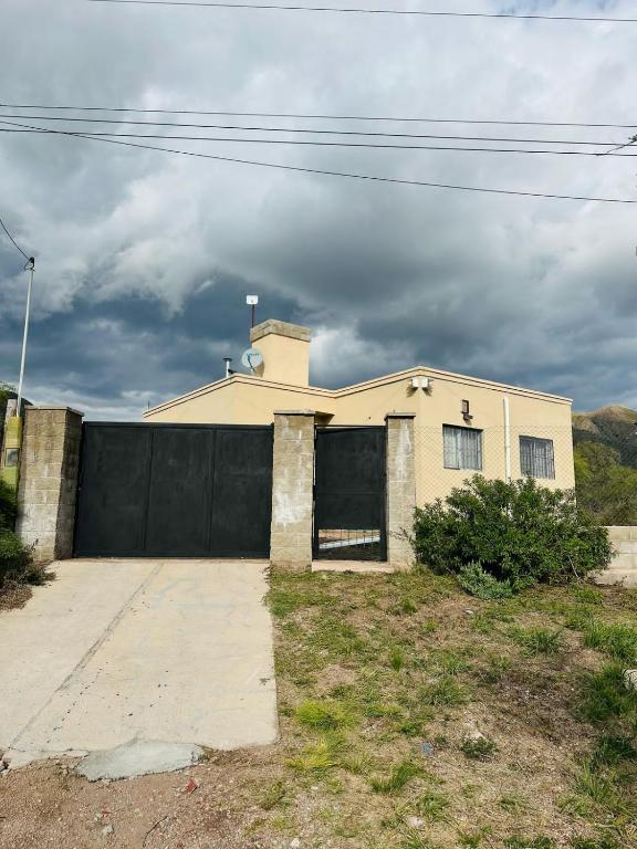 a house with a black fence and a garage at esfuerzo in La Punta
