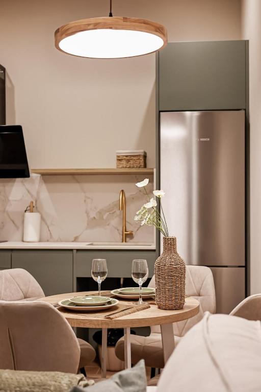a kitchen with a table and a refrigerator at Arima Apartamentuak 1, Moderno, accesible in Getaria
