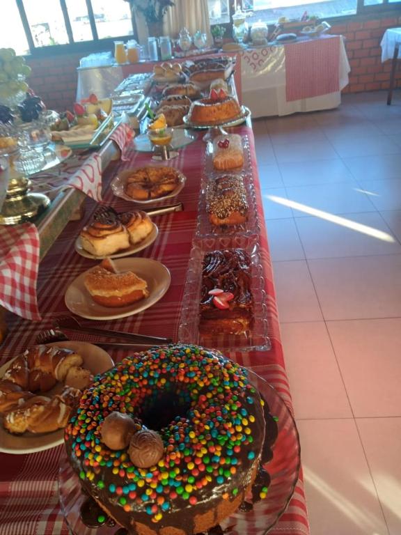 a long table with many donuts and plates of food at Oceano Hotel in Torres