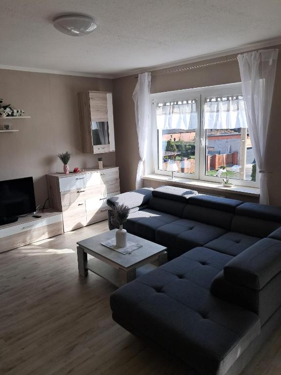 a living room with a couch and a table at Monteurzimmer Rochau in Rochau