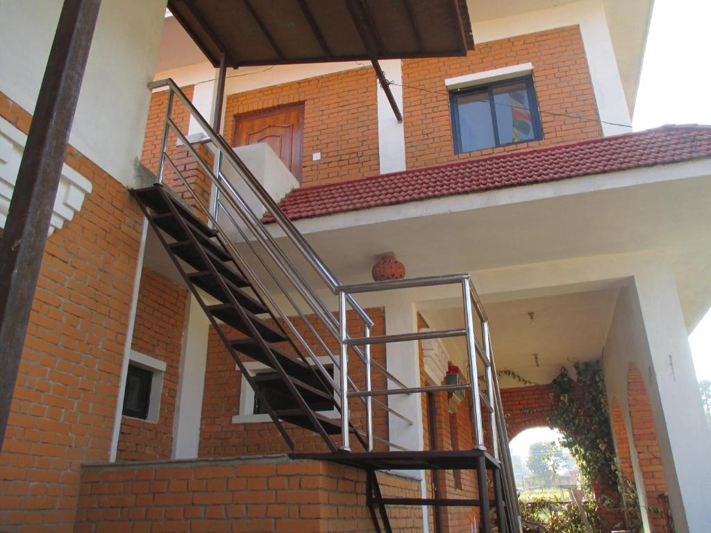 a staircase in a house with a brick wall at Hotel Swiss in Pharping