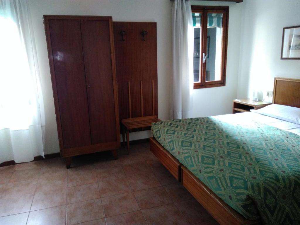 Postel nebo postele na pokoji v ubytování Albergo Al Gobbo