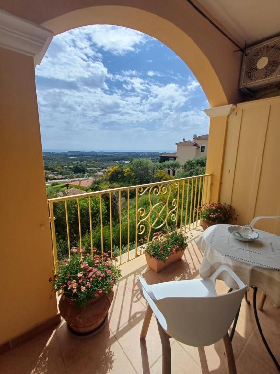 a balcony with a table and chairs and a view at RoomAntic House in Is Molas 
