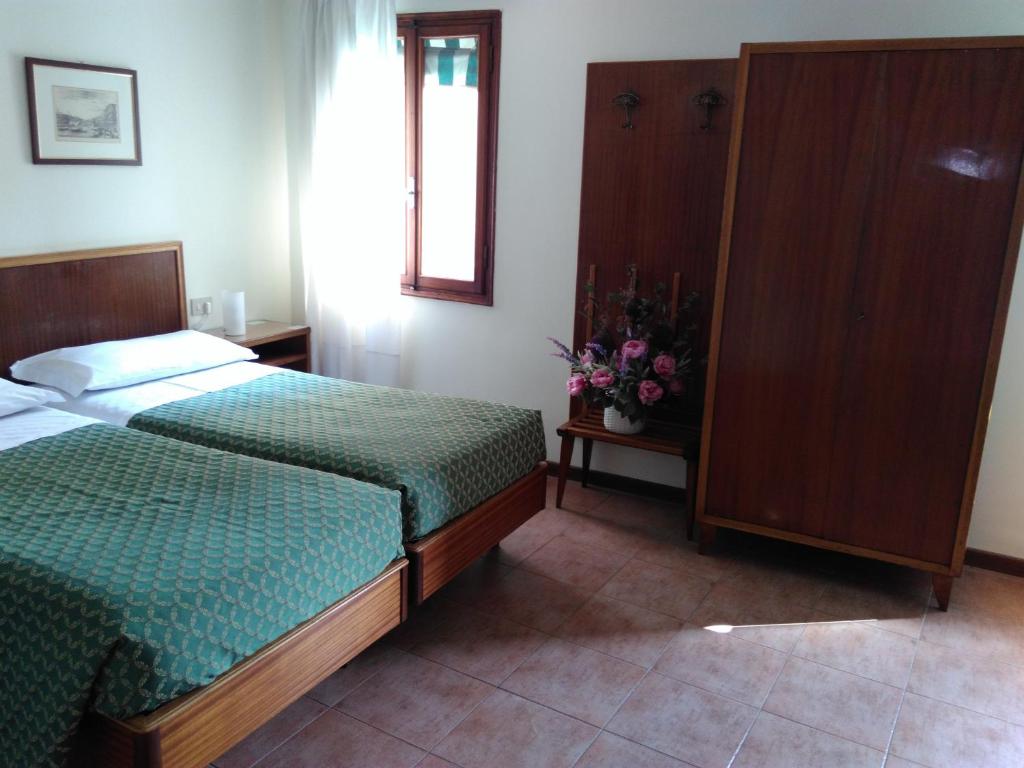 Postel nebo postele na pokoji v ubytování Albergo Al Gobbo