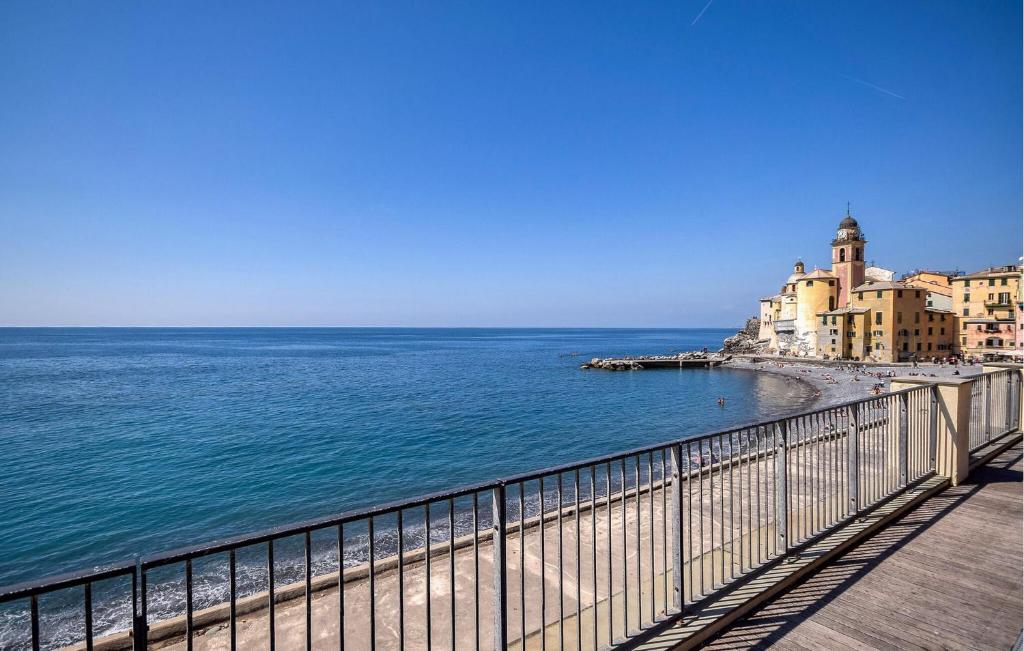 a view of a beach with buildings and the ocean at 4 Bedroom Lovely Apartment In Camogli in Camogli