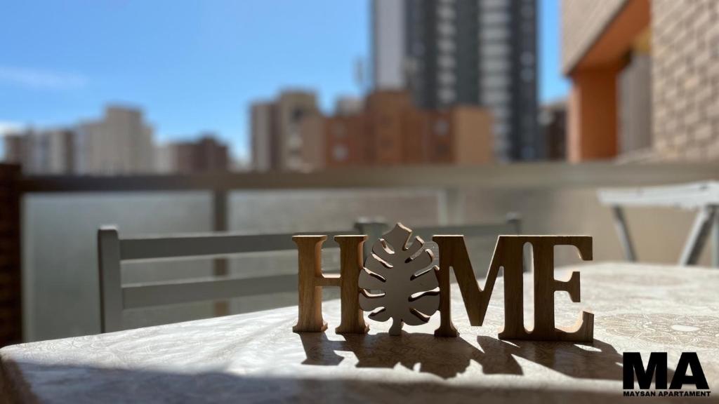 a table with the word home written on it at Maysan Apartamento in Benidorm