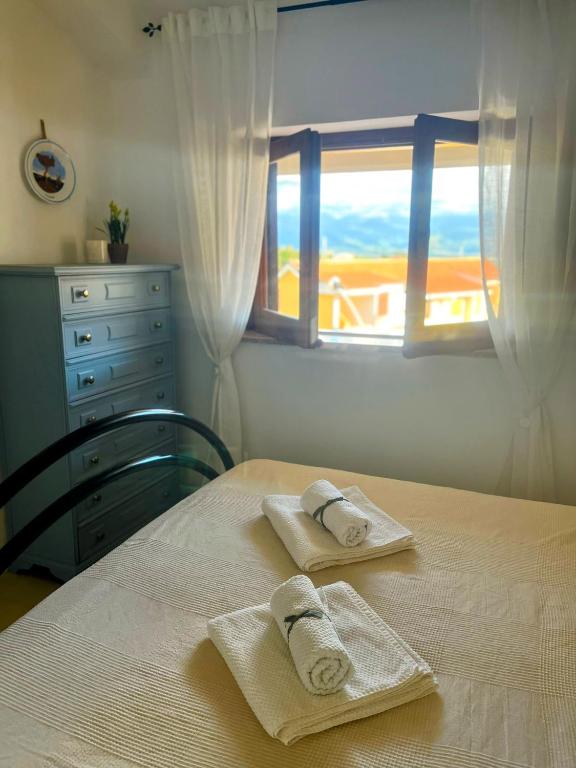 a bedroom with a table with towels on it at Bella Vista La Bussola in Scalea