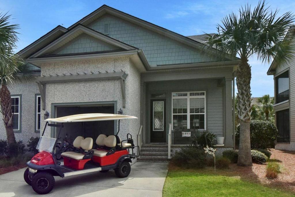 a golf cart parked in front of a house at Garden Cottage 09 in Jekyll Island