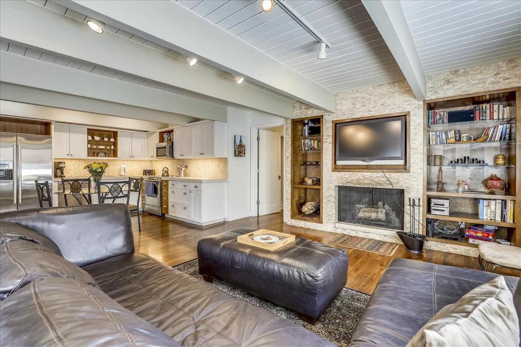 a living room with a couch and a fireplace at Walk Everywhere! Deluxe Aspen Condo in Aspen