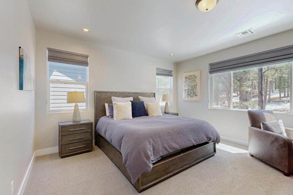 a bedroom with a bed and a window and a chair at Pinnacle Pines in Flagstaff