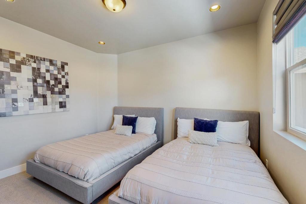 two beds sitting next to each other in a room at Pinnacle Pines in Flagstaff