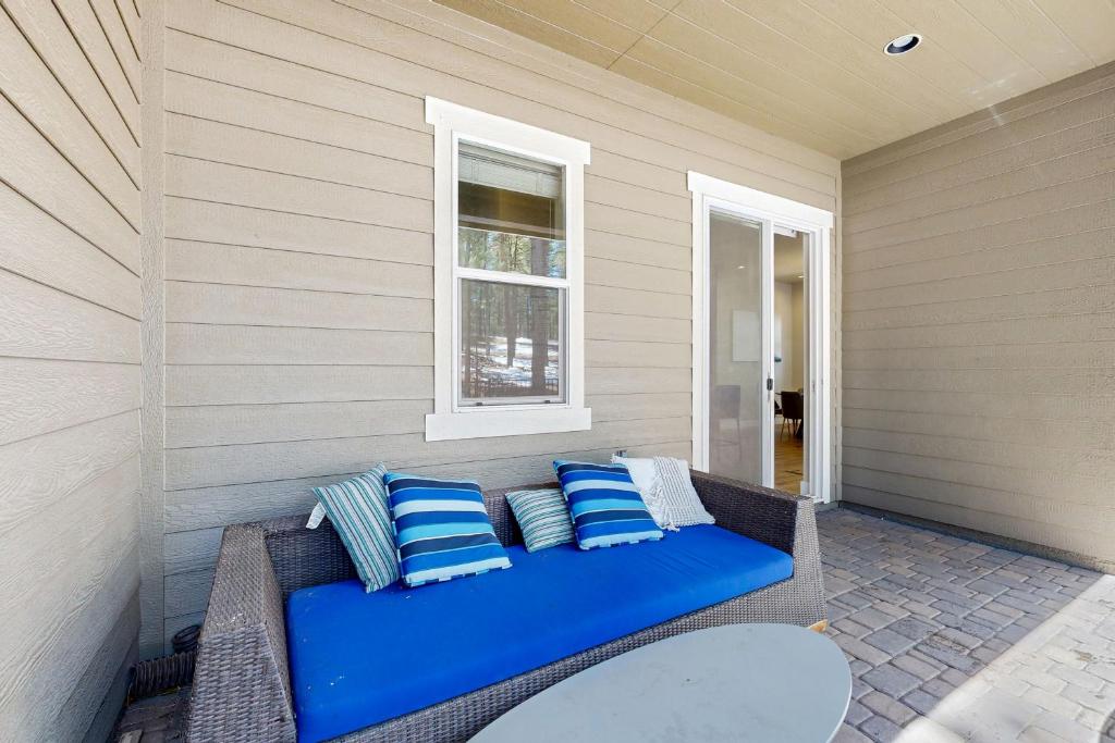 a blue couch on a porch with a window at Pinnacle Pines in Flagstaff