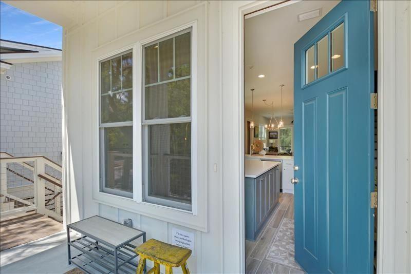 a house with a blue door and a kitchen at Moorings 43 in Jekyll Island