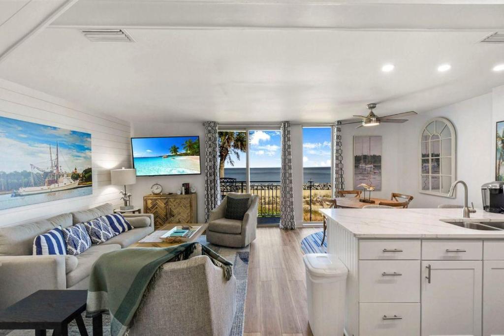a kitchen and living room with a couch and a table at Villa 129 in Jekyll Island