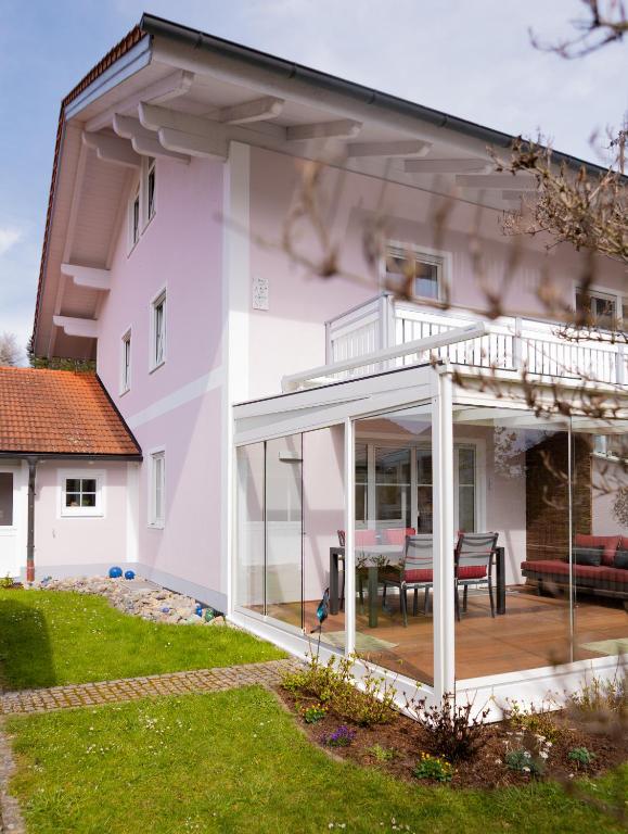 an extension of a house with a deck and patio at AlzBlüte in Truchtlaching