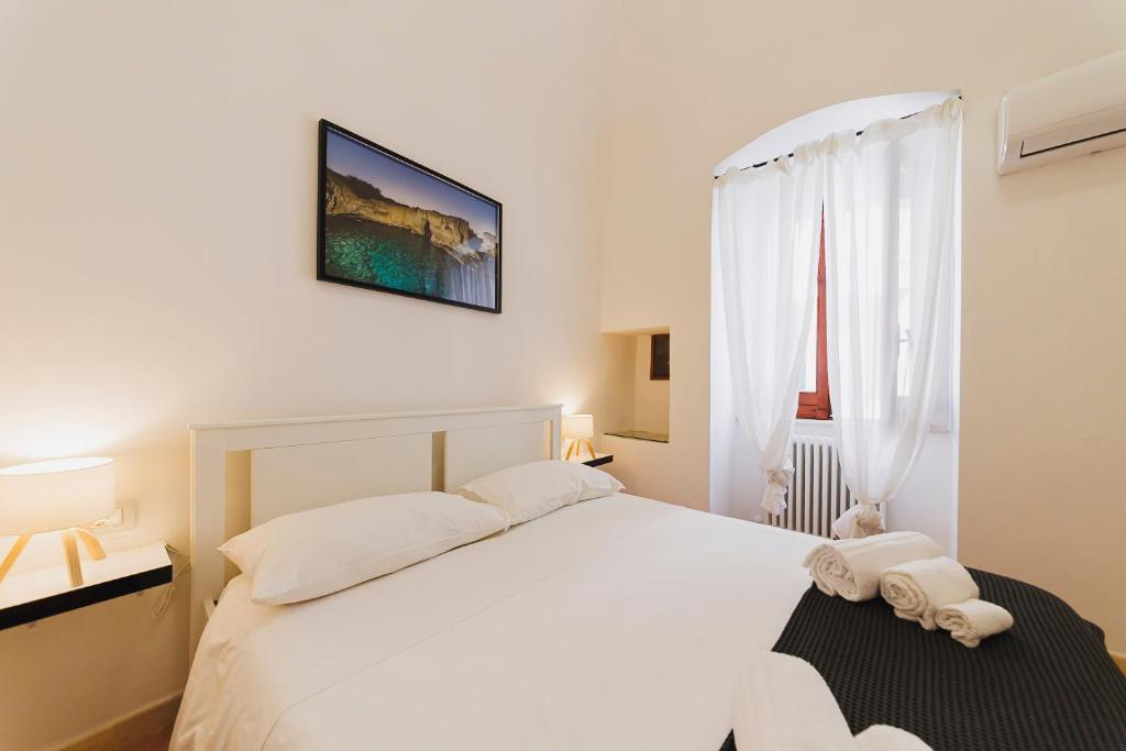 Postel nebo postele na pokoji v ubytování Don Ciccio Apartments&Suite