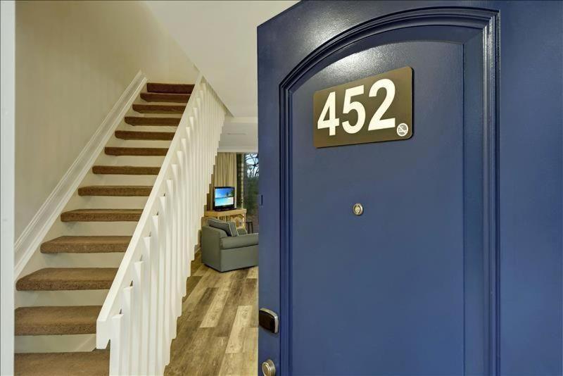 a house with a blue door with at Villa 452 in Jekyll Island