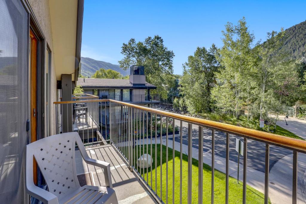 a balcony with a chair and a view of a street at Spacious Top Floor Condo Aspen in Aspen