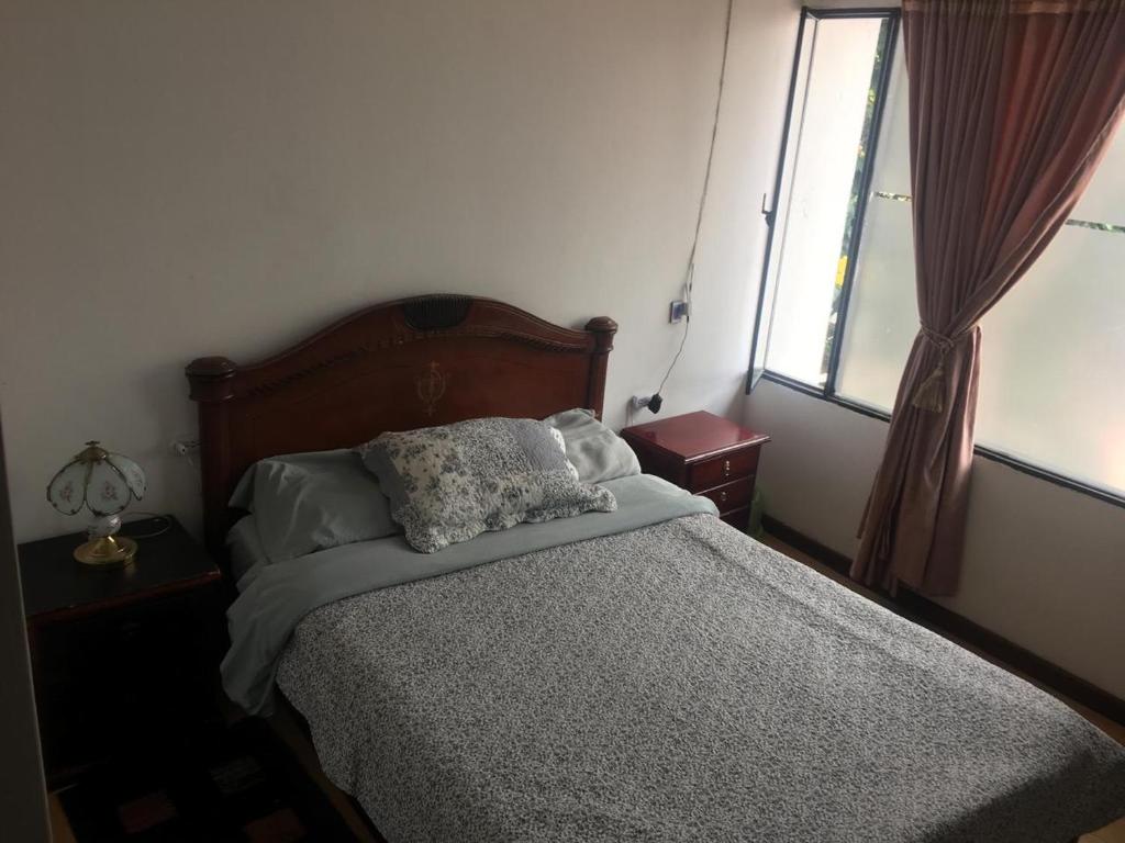 a bedroom with a bed with two pillows on it at Apartamento 201 completo Chía Norte in Chía