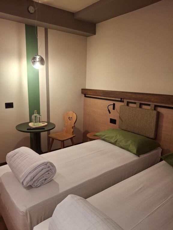 Postel nebo postele na pokoji v ubytování Hotel Dolomiti Saone