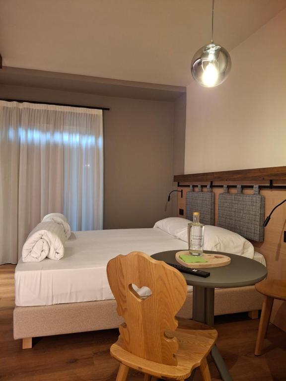 Postel nebo postele na pokoji v ubytování Hotel Dolomiti Saone
