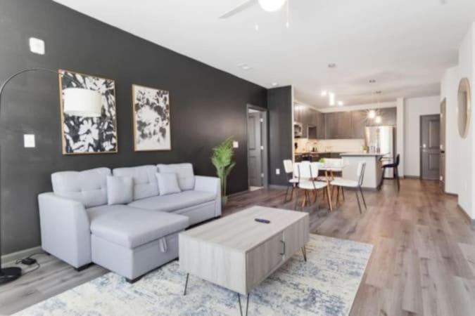 a living room with a white couch and a table at Luxurious King 2BR Suite in North Raleigh! in Raleigh