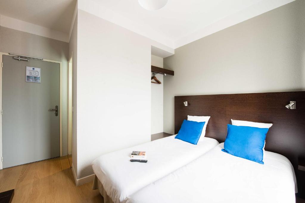 Postel nebo postele na pokoji v ubytování Hôtel Atrium