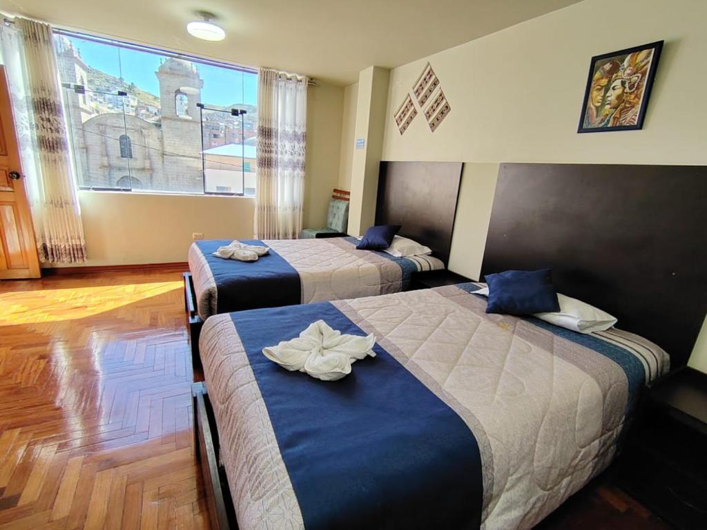 Postel nebo postele na pokoji v ubytování Hostal San Antonio Inn