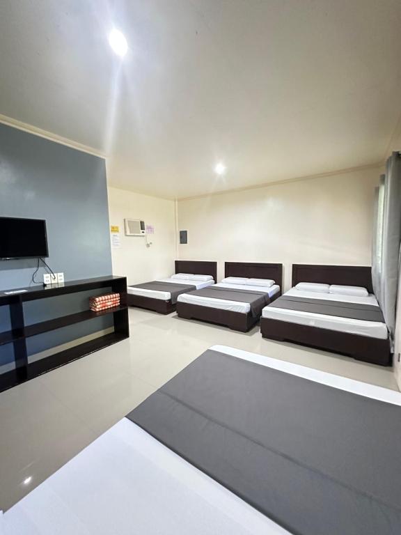 Ένα ή περισσότερα κρεβάτια σε δωμάτιο στο Veance Travellers Inn-Pabuas extension