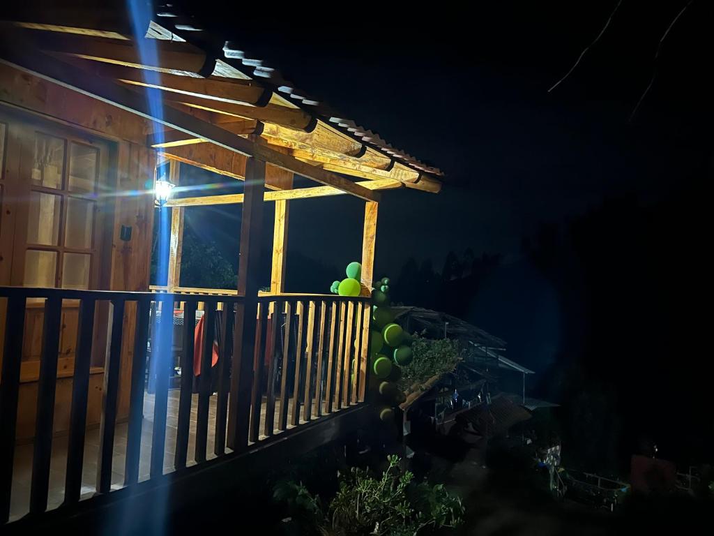 a porch at night with a bunch of fruit on the railing at Lodge CAllacpuma in San Antonio