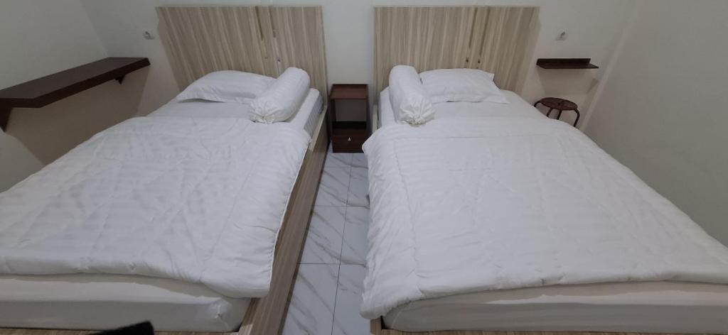 Postel nebo postele na pokoji v ubytování Homestay Sa'adah