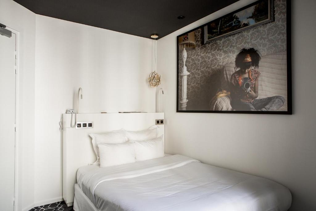 Postel nebo postele na pokoji v ubytování Le Général Hôtel