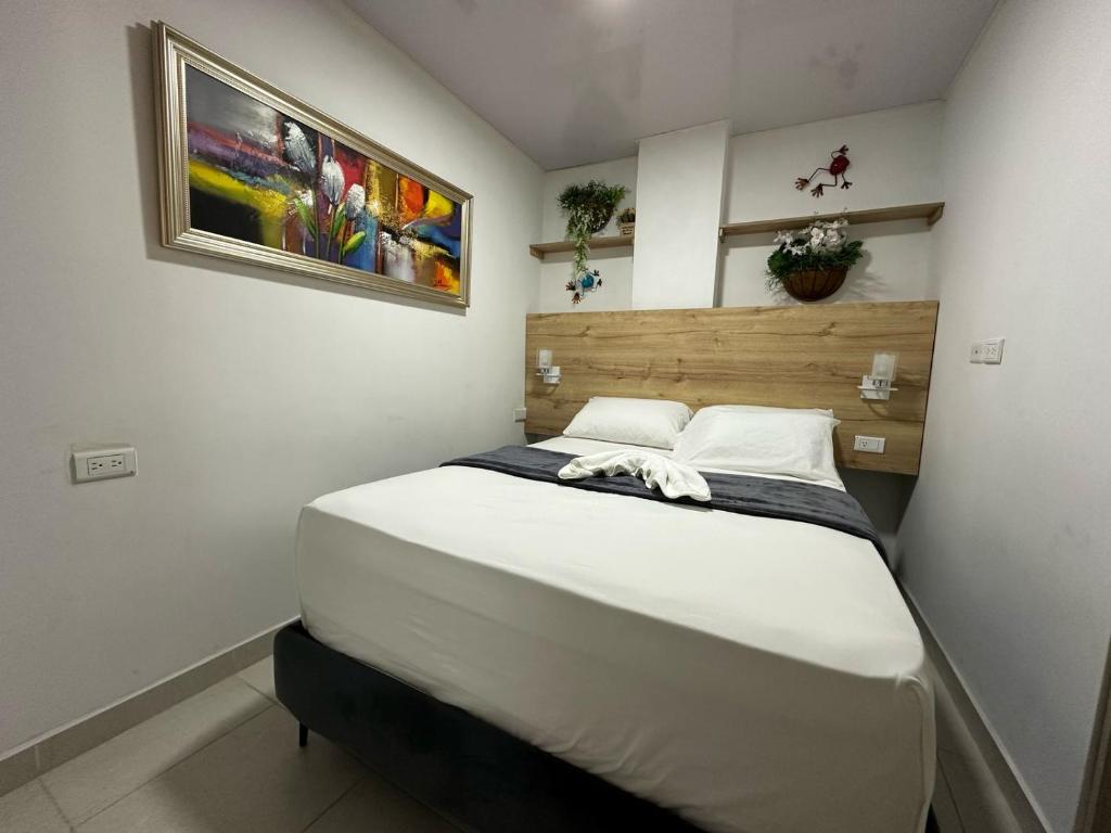 Postel nebo postele na pokoji v ubytování HospedArte Cali