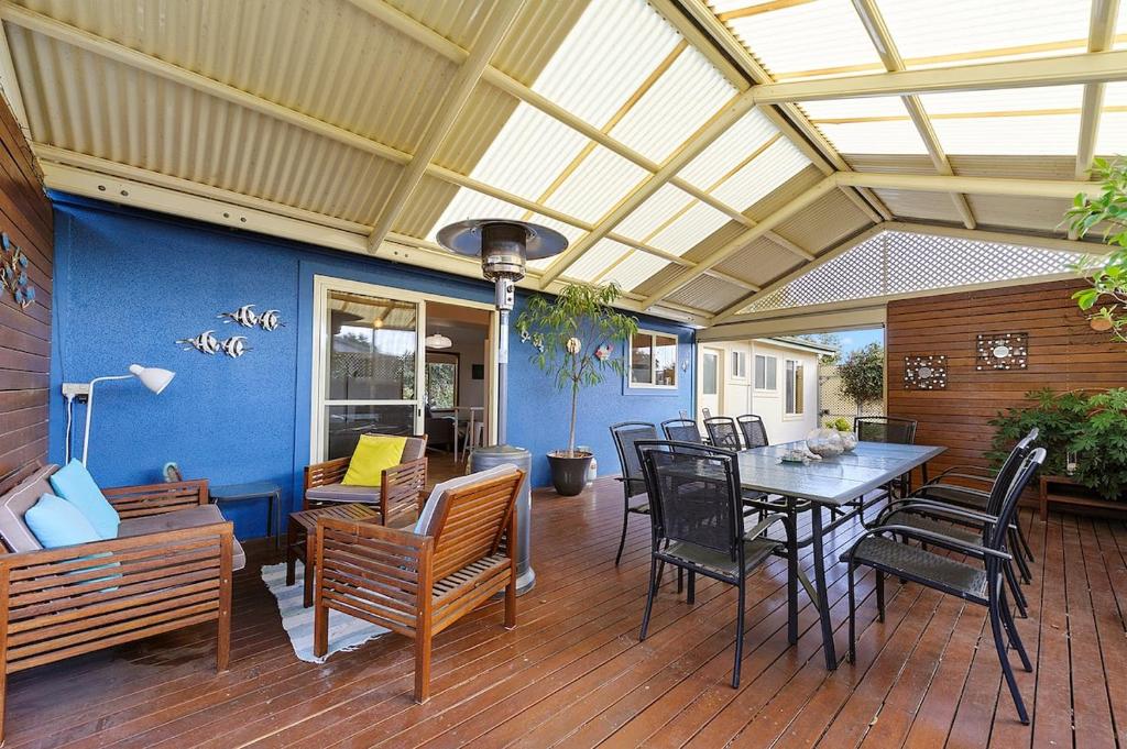 a patio with a table and chairs on a deck at Bayhaven- Best deal 4 bedroom 2 bathroom getaway in Port Moonta