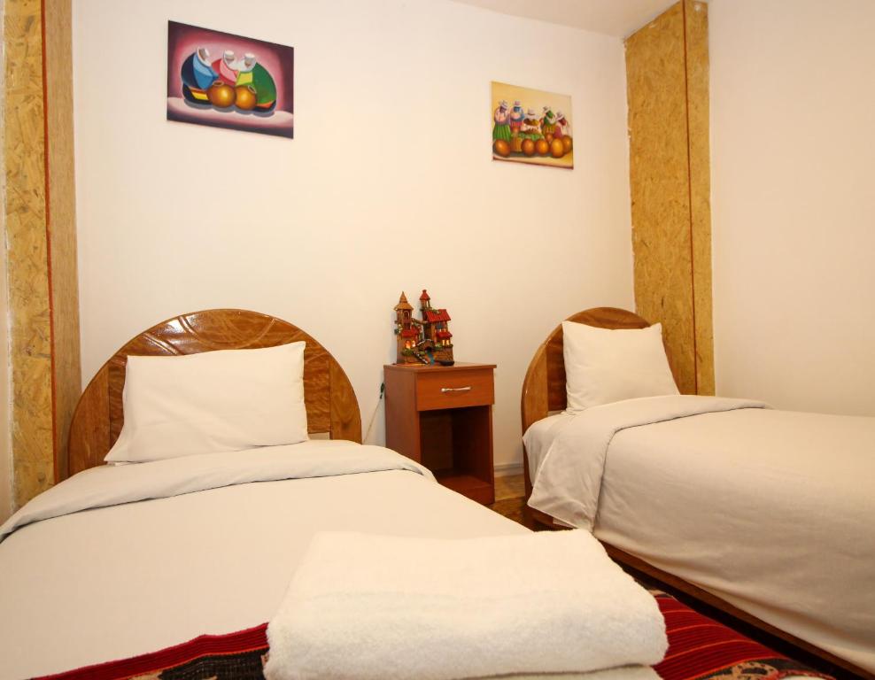 Rúm í herbergi á Cusco Qori Sisa Hostal