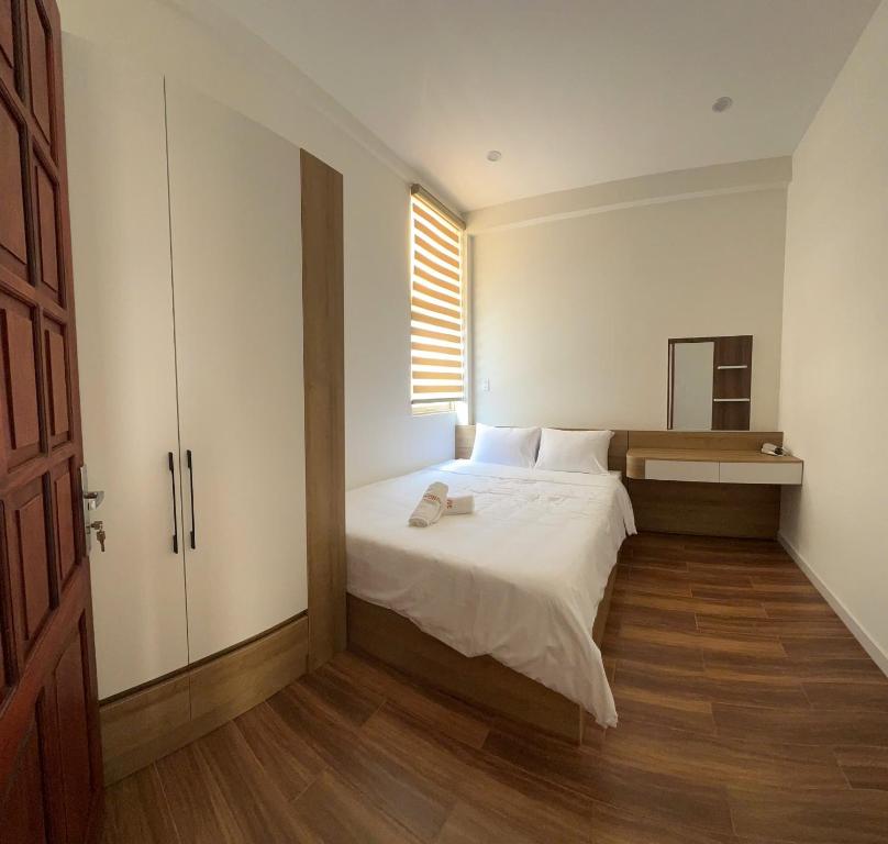 Postel nebo postele na pokoji v ubytování Wonder House Dalat