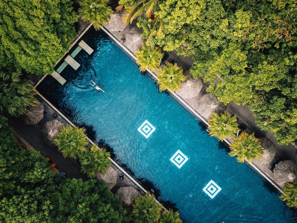 an overhead view of a pool of water with palm trees at Pilgrimage Village Boutique Resort & Spa in Hue