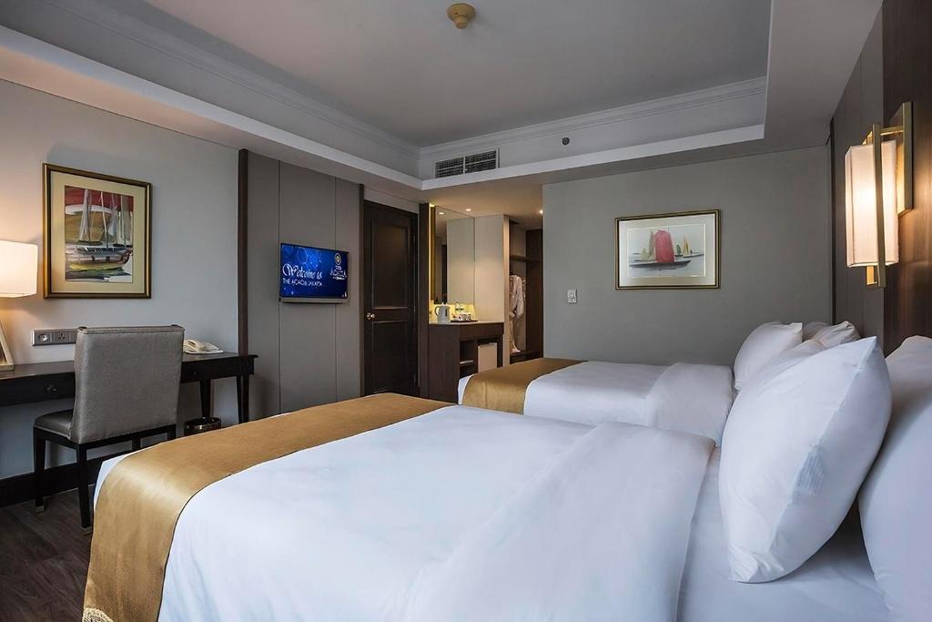 Postel nebo postele na pokoji v ubytování The Acacia Hotel Jakarta