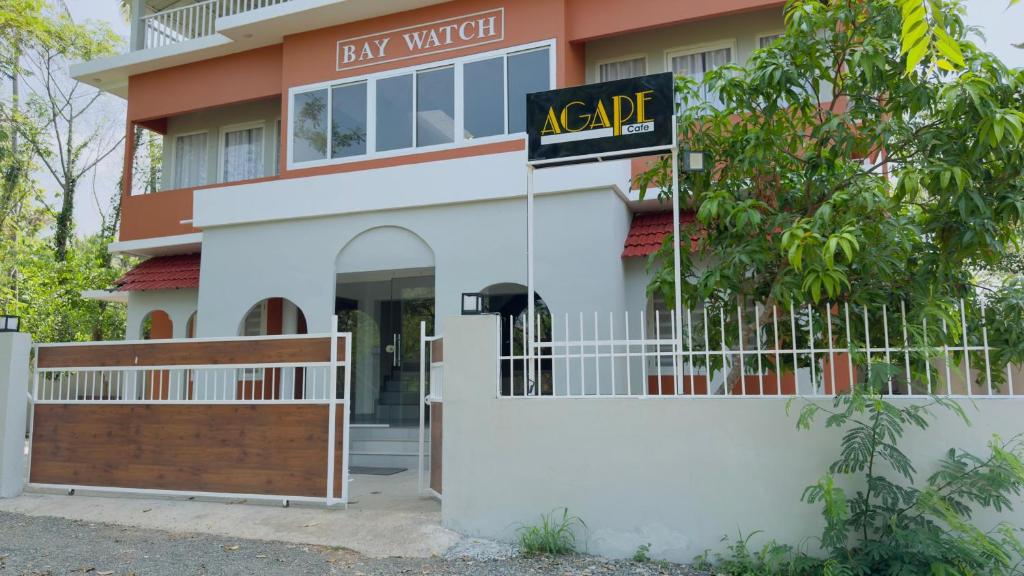 a sign in front of a large building at Baywatch by Malabar Tourism in Azhikal